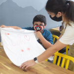 kid shows off t shirt decoration
